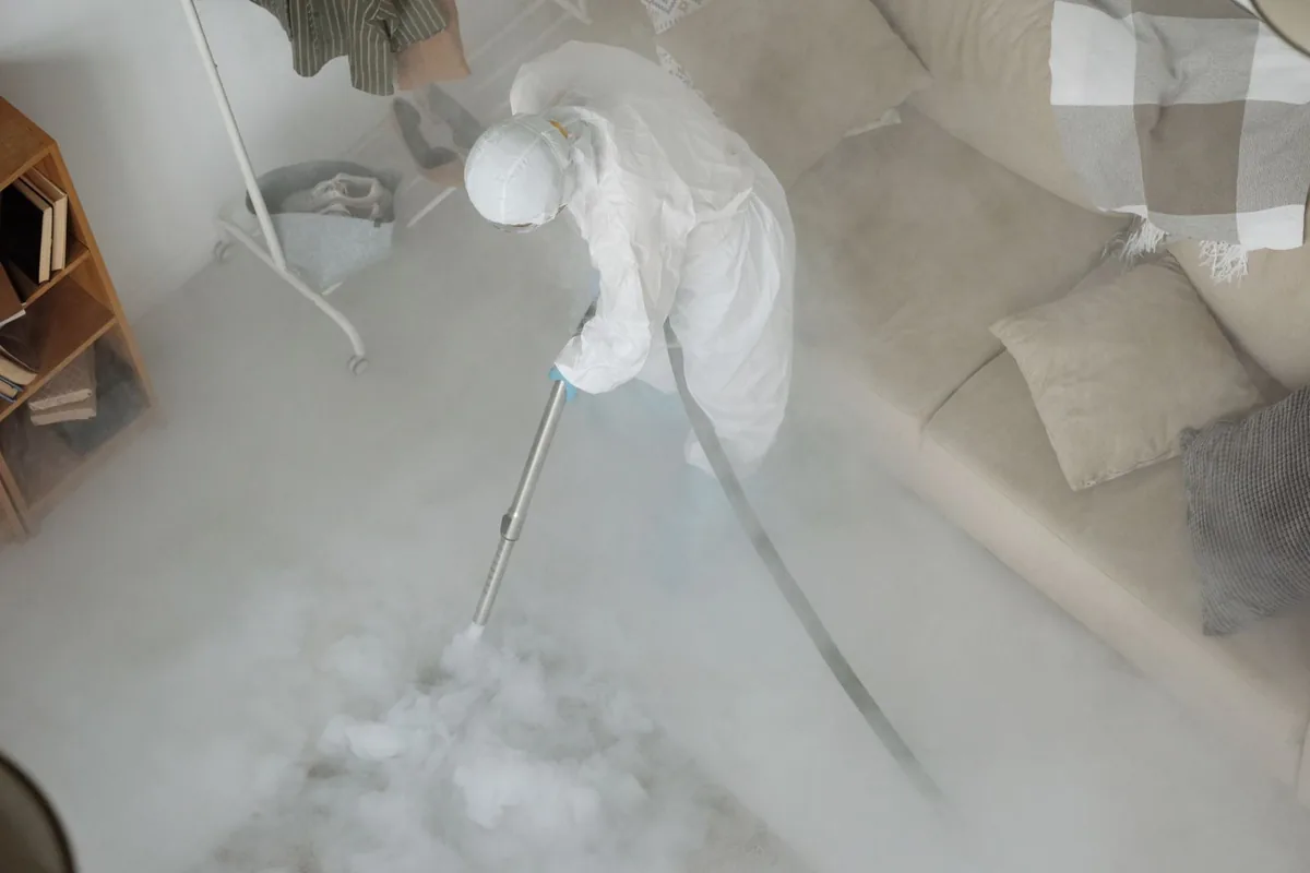 Biohazard cleanup technician in protective equipment, Nevada, IA